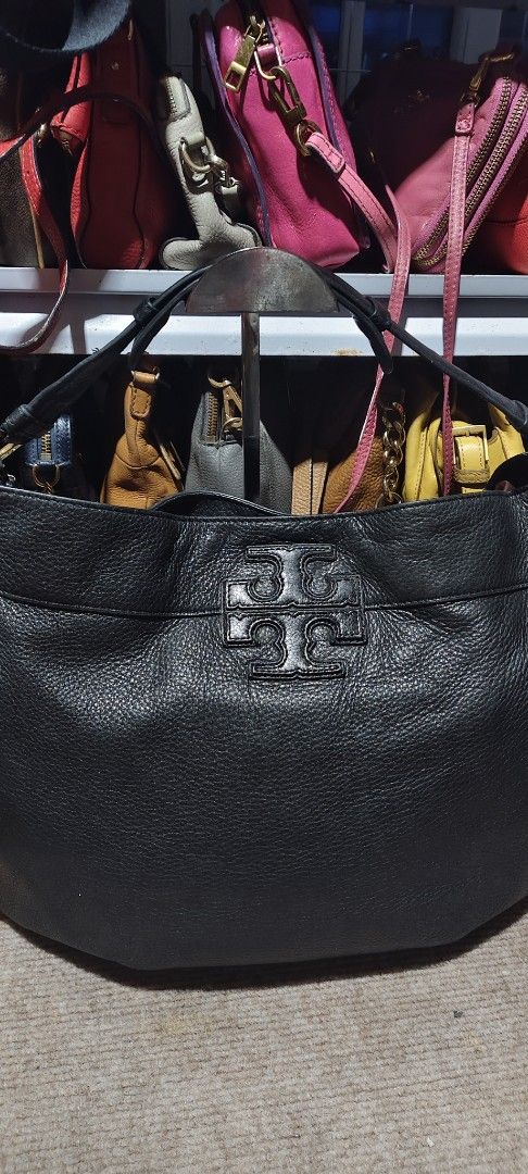 Tory Burch Black Leather Tote Bag (Category: Tote Bags) located in Solano. Submitted by chie_prelovedthriftshop (Listing ID 1464630897, Image 2). Description: Black leather Tory Burch tote bag. Spacious interior. Comfortable shoulder straps. Embossed Tory Burch logo on the front. Great everyday bag. Some signs of wear on the leather and hardware. needs wash inside.