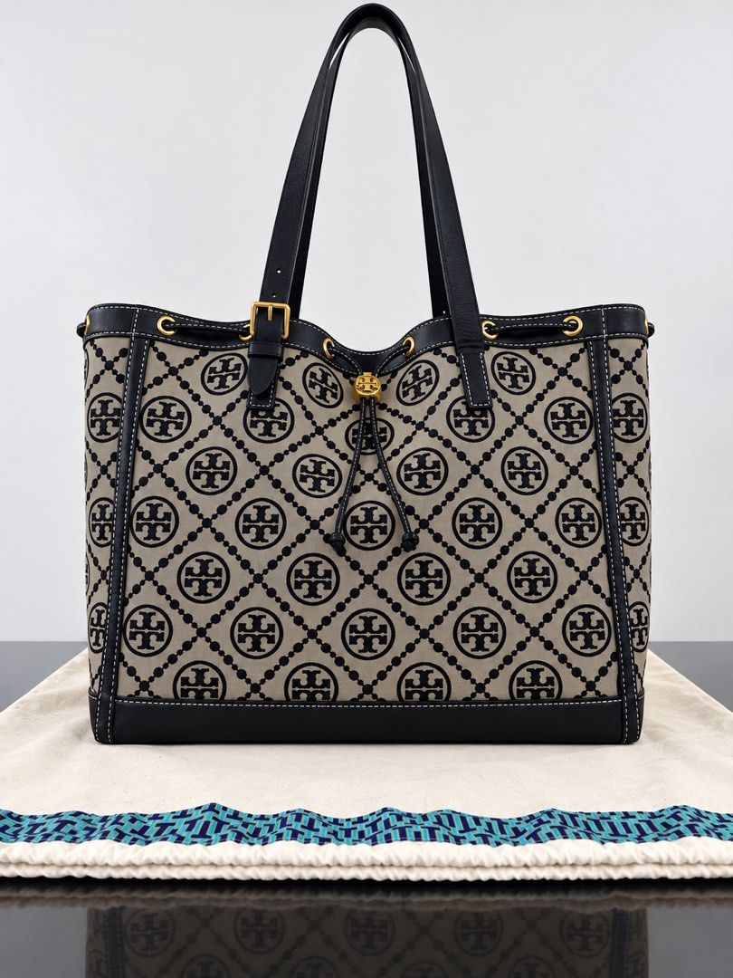Tory Burch Monogram Tote Bag (Category: Luxury Bags & Wallets) located in Paranaque City. Submitted by katlouieleandicho (Listing ID 1464602578, Image 2). Description: 💯Authentic Personal Collection - used once Dimensions: W 19.5in x H 11.5in x D 7in Tory Burch Monogram Tote Bag — Classic beige and dark blue monogram canvas tote with dark blue leather trim, gold-tone hardware, and spacious interior. A timeless everyday bag with a versatile desig