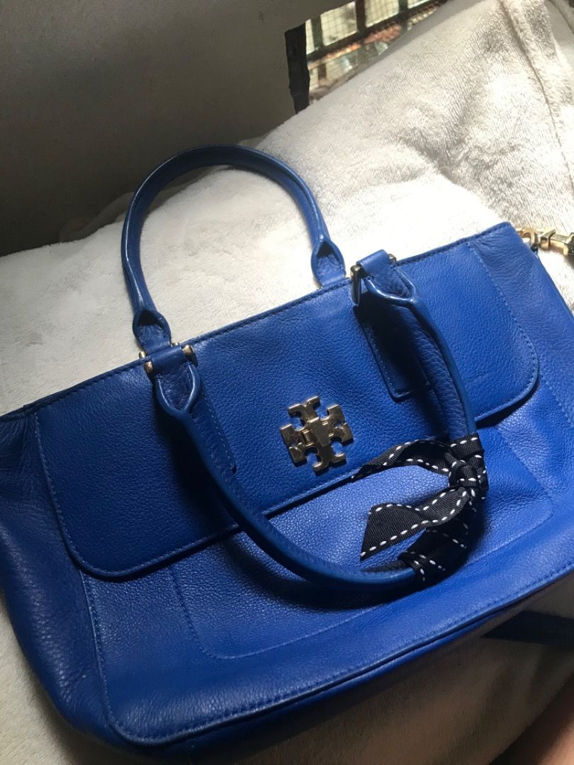 Tory Burch Royal Blue Leather Tote Bag (Category: Tote Bags) located in Manila. Submitted by jeji1208 (Listing ID 1464589221, Image 2). Description: - Authentic Tory Burch leather tote bag - Stunning royal blue color - Iconic gold Tory Burch logo on the front - Versatile carrying options: top handles and detachable shoulder strap - Spacious interior for all your essentials - Chic detail: small black and white ribbon tied to one handle.