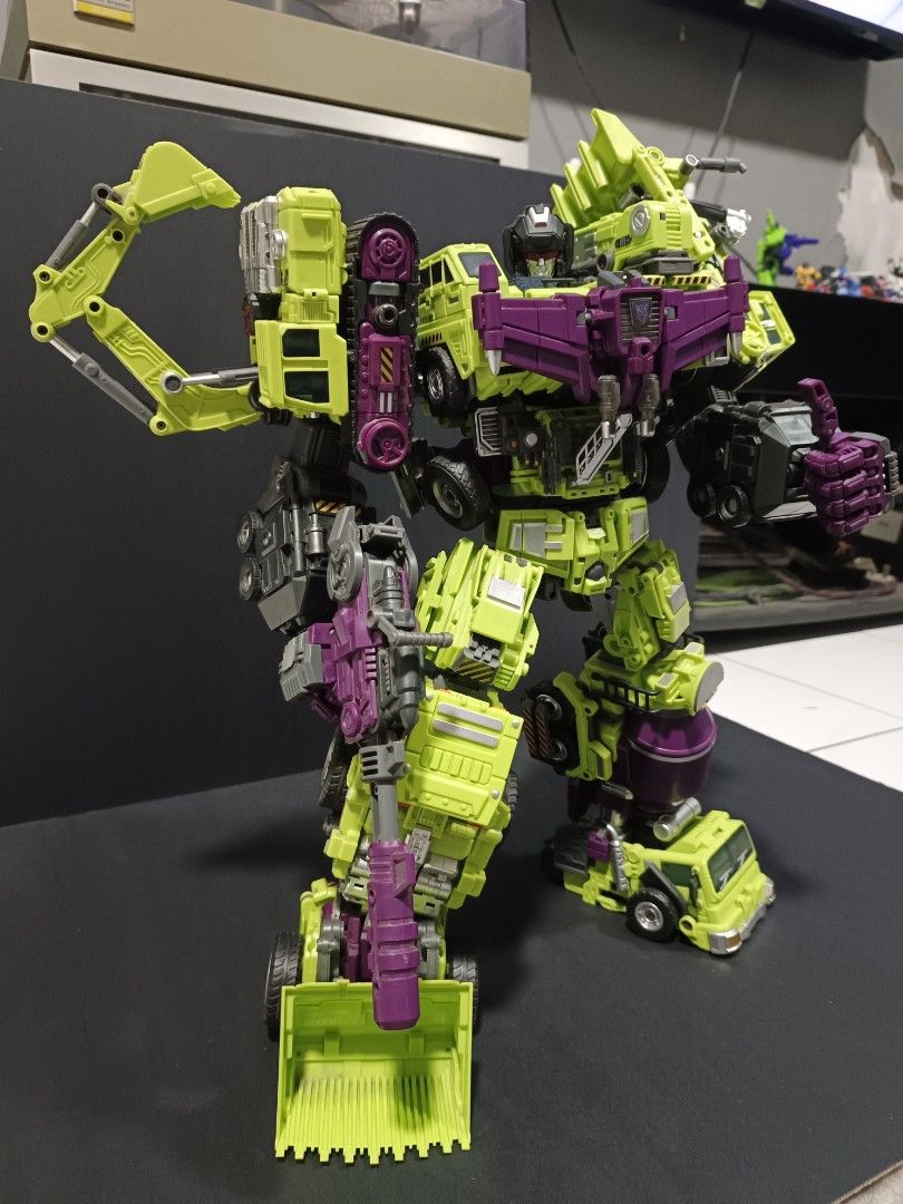 Transformers Devastator (Jinbao version) (Category: Action & Battle Toys) located in Kuala Lumpur. Submitted by nabilhuda26 (Listing ID 1464731417, Image 2). Description: Massive combiner robot in iconic green and purple constructicon colours. Highly articulated with detailed mechanical parts, individual vehicle components combined together. Stands tall holding a large blaster weapon. Posed and ready for display. Joints firm, painted details inta