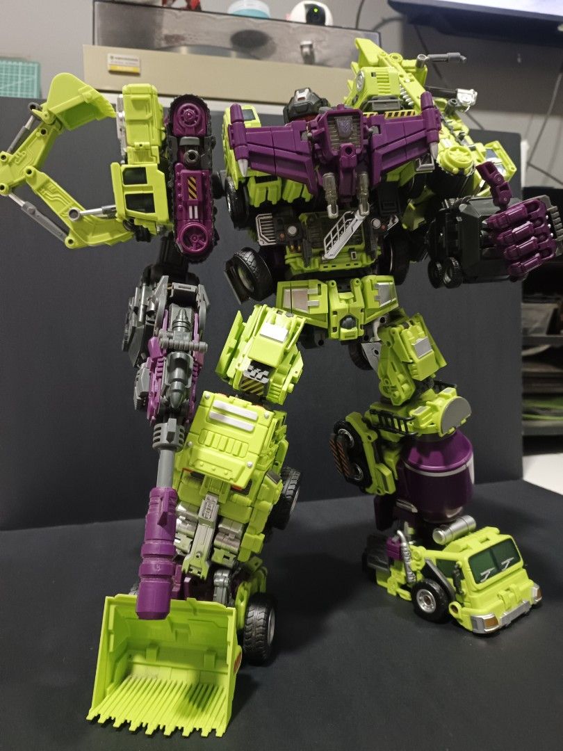 Transformers Devastator (Jinbao version) (Category: Action & Battle Toys) located in Kuala Lumpur. Submitted by nabilhuda26 (Listing ID 1464731417, Image 3). Description: Massive combiner robot in iconic green and purple constructicon colours. Highly articulated with detailed mechanical parts, individual vehicle components combined together. Stands tall holding a large blaster weapon. Posed and ready for display. Joints firm, painted details inta