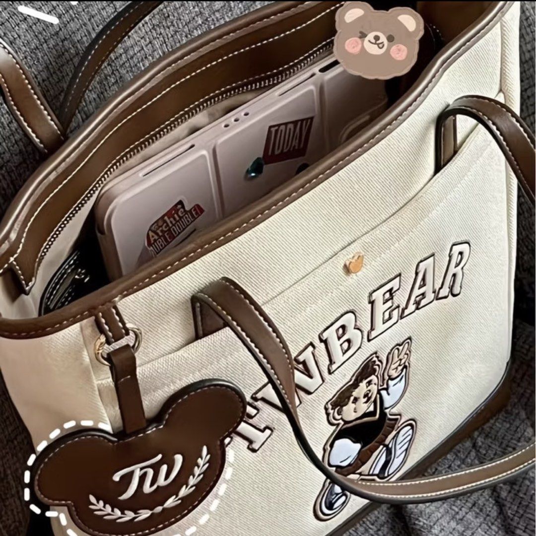 TW Bear Canvas Tote Bag with Leather Trim (Category: Tote Bags) located in Manila. Submitted by shayne2 (Listing ID 1464573600, Image 2). Description: With small inner lining issue need kng tahiin if u want. As seen on last pic not a big deal - Adorable canvas tote bag featuring a cute bear graphic. - 'TWBEAR' embroidery adds a unique touch. - Stylish faux leather trim and handles. - Convenient inner pocket with magnetic snap closure. - Handy ext