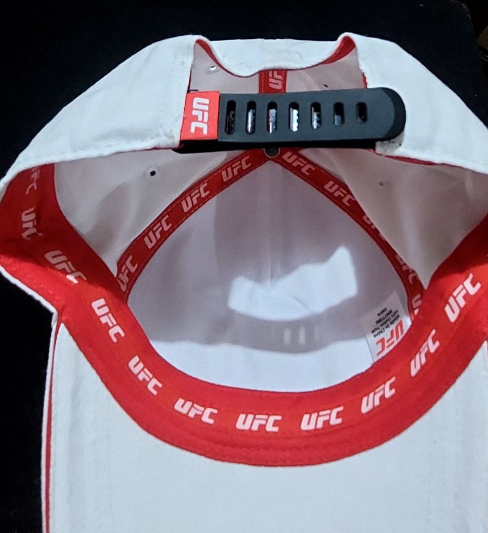 UFC White Cap Adjustable Snapback (Category: Caps & Hats) located in Legazpi City. Submitted by street_uniform (Listing ID 1464740375, Image 3). Description: - 100% authentic UFC merchandise in clean white cotton twill - Features a bold digital camouflage logo with striking red branding details - Adjustable plastic snapback closure for a comfortable, custom fit - Premium interior finish with branded red UFC seam tape - Condition: Brand new / Exce