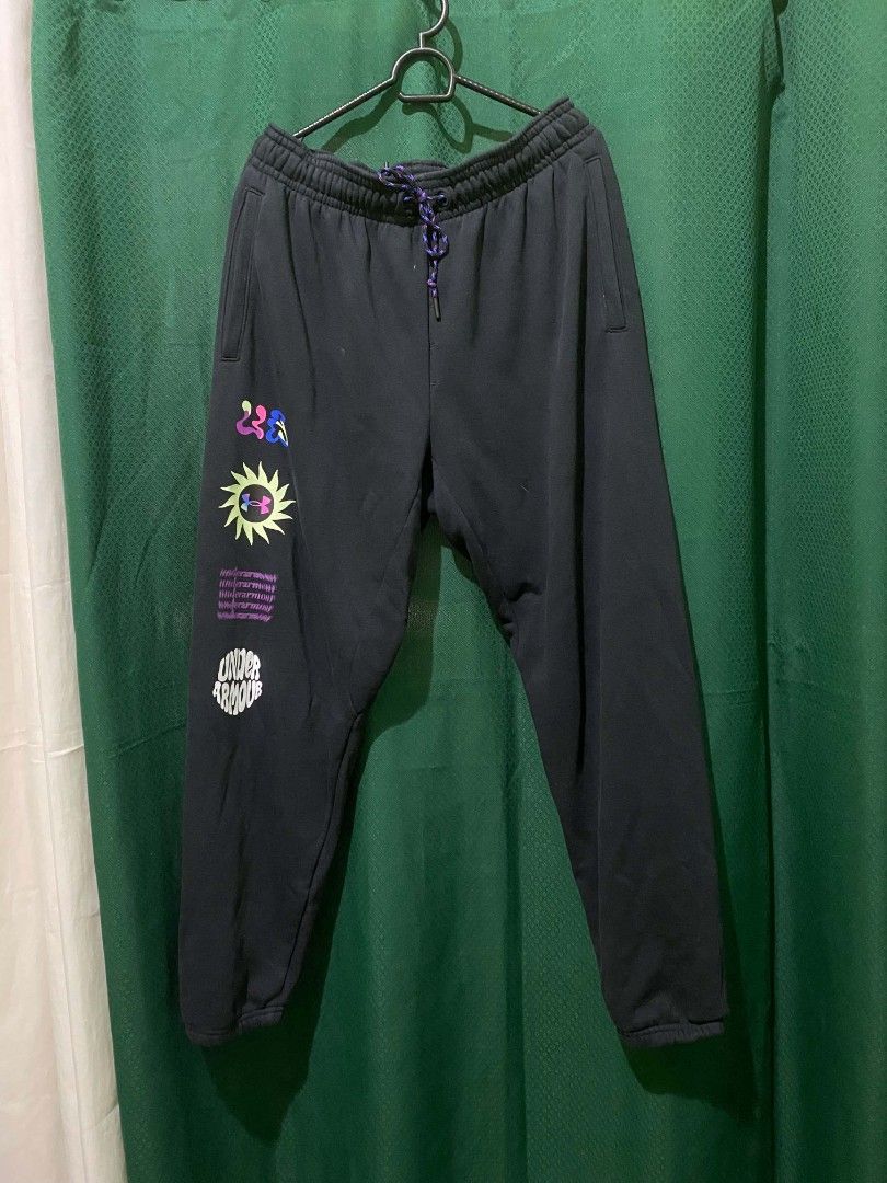Under Armour Black Graphic Sweatpants XXL (Category: Joggers) located in Quezon City. Submitted by elihur.tuazon (Listing ID 1464736585, Image 2). Description: - Brand: Under Armour - Size: XXL (Plus size) - Color: Black fleece - Details: Multicolored speckled drawstring, side pockets, ribbed ankle cuffs - Graphic: Fun colorful sun motif and distorted UA text on the right leg - Origin: Made in Malaysia - Condition: Great for lounging, workouts, a