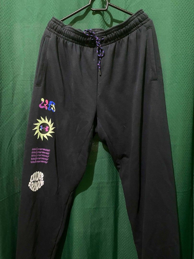 Under Armour Black Graphic Sweatpants XXL (Category: Joggers) located in Quezon City. Submitted by elihur.tuazon (Listing ID 1464736585, Image 1). Description: - Brand: Under Armour - Size: XXL (Plus size) - Color: Black fleece - Details: Multicolored speckled drawstring, side pockets, ribbed ankle cuffs - Graphic: Fun colorful sun motif and distorted UA text on the right leg - Origin: Made in Malaysia - Condition: Great for lounging, workouts, a