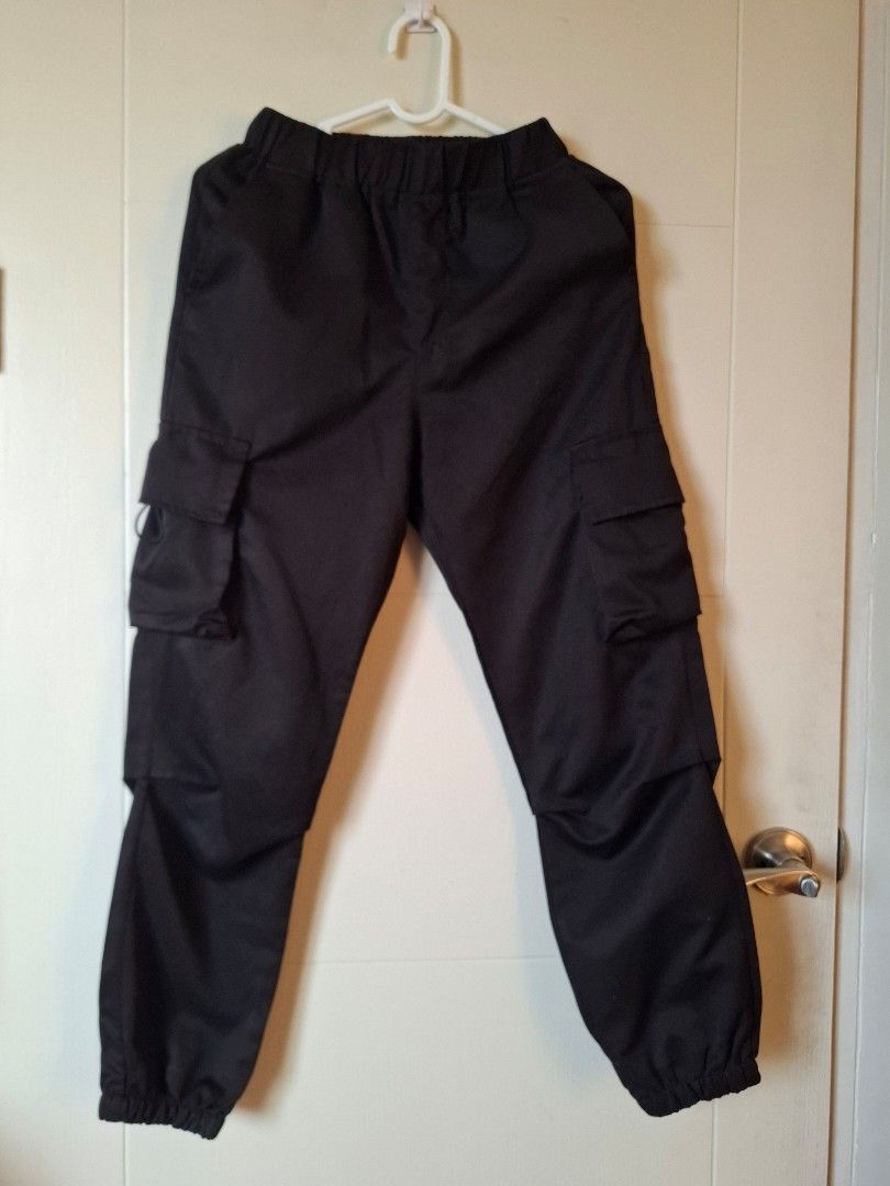 Uniqlo Black Cargo Pants Size 12Y (Category: Babies & Kids Fashion) located in Makati City. Submitted by chyna527 (Listing ID 1464768229, Image 1). Description: - Color: Solid black - Size: Tagged 12Y - Waist: Elastic waistband for easy and comfortable fit - Pockets: Utility pockets on both legs - Details: Cuffed ankles at the bottom - Origin: Made in China - Condition: Clean fabric, excellent ready-to-wear condition.