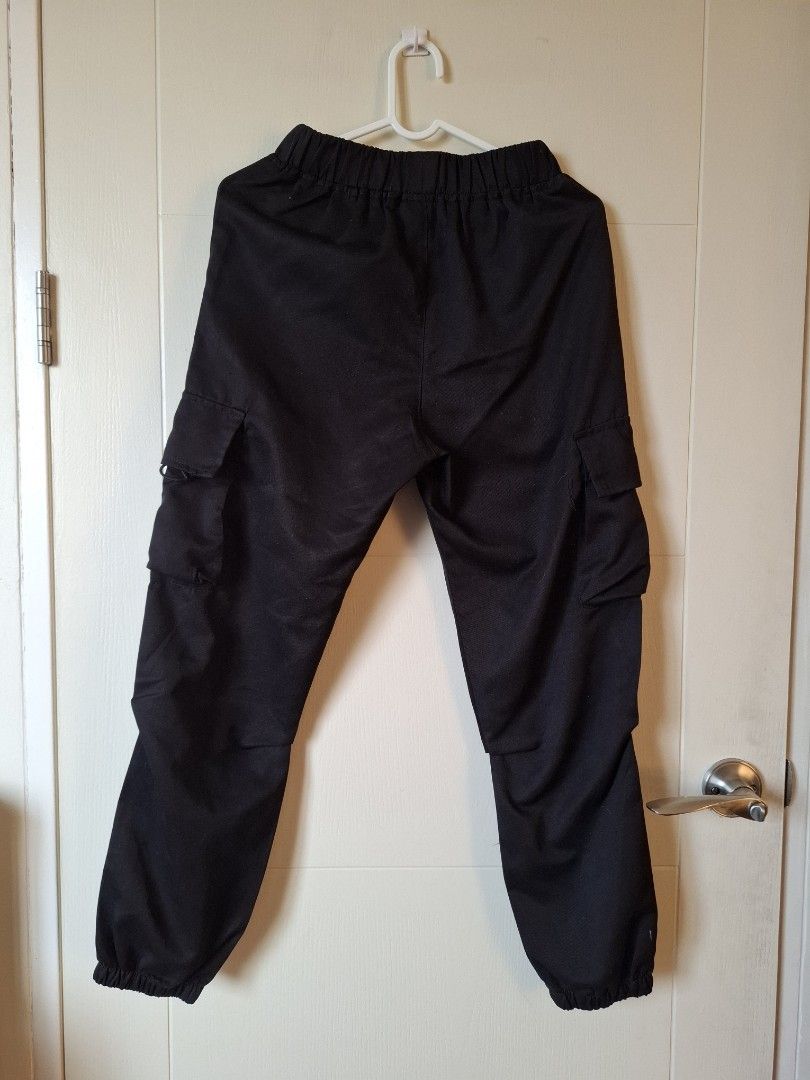 Uniqlo Black Cargo Pants Size 12Y (Category: Babies & Kids Fashion) located in Makati City. Submitted by chyna527 (Listing ID 1464768229, Image 3). Description: - Color: Solid black - Size: Tagged 12Y - Waist: Elastic waistband for easy and comfortable fit - Pockets: Utility pockets on both legs - Details: Cuffed ankles at the bottom - Origin: Made in China - Condition: Clean fabric, excellent ready-to-wear condition.