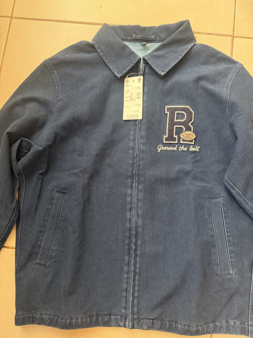 Uniqlo Kids Denim Jacket with 'R' Patch (Category: Babies & Kids Fashion) located in Makati City. Submitted by etherealuxe.ph (Listing ID 1464627048, Image 3). Description: Brand New Uniqlo Kids Jersey Work Jacket Dark Denim in person. Photo color may be different due to lighting. - Blue denim jacket for kids - Features a cool 'R' patch with a football and 'Ground the ball' text - Zip-up front closure - Two side pockets - Perfect for casual wear 