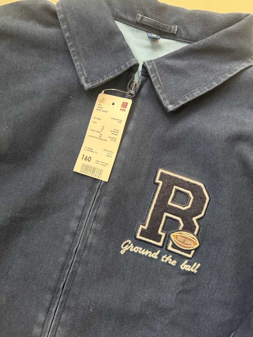 Uniqlo Kids Denim Jacket with 'R' Patch (Category: Babies & Kids Fashion) located in Makati City. Submitted by etherealuxe.ph (Listing ID 1464627048, Image 2). Description: Brand New Uniqlo Kids Jersey Work Jacket Dark Denim in person. Photo color may be different due to lighting. - Blue denim jacket for kids - Features a cool 'R' patch with a football and 'Ground the ball' text - Zip-up front closure - Two side pockets - Perfect for casual wear 