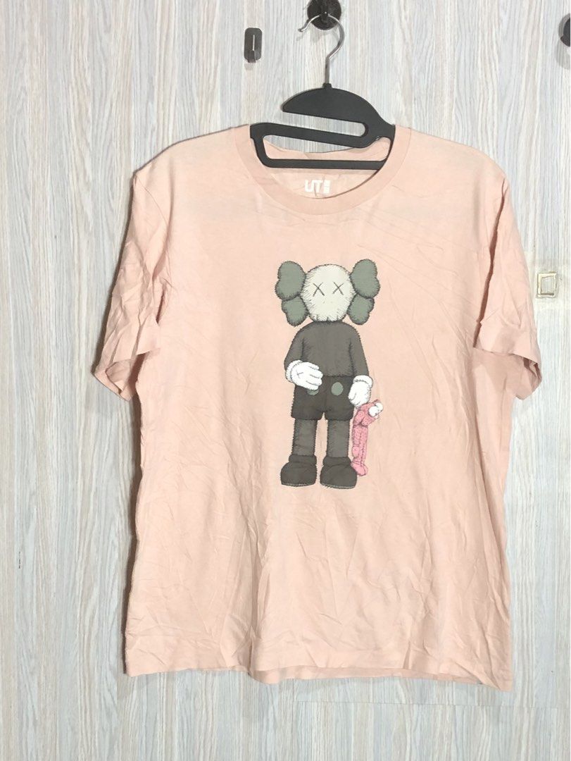 Uniqlo UT KAWS Pink Graphic Tee (Category: Shirts) located in Montevista. Submitted by rdthriftshub (Listing ID 1464756281, Image 1). Description: - Authentic Uniqlo UT x KAWS collaboration piece - Color: Pale pink with iconic front Companion graphic - Material: Comfortable 100% cotton - Fit: Standard crew neck and short sleeves - Details: Official KAWS and Uniqlo branding inside the collar - Condition: Excellent everyday streetwear essential.