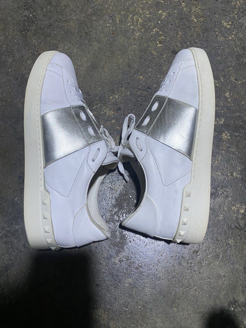 Valentino Garavani (Category: Sneakers & Footwear) located in Davao. Submitted by eziekelmoral (Listing ID 1464700786, Image 3). Description: Valentino Garavani Open Rockstud sneakers, featuring a sleek white leather body accented by a metallic silver side band and signature rubber studs along the heel Size :42 Excellent to good condition Color rate : 9.5/10 Sign of used only .