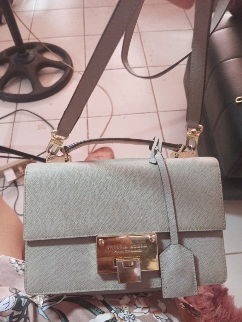 VERELLI NOCCA Grey Structured Handbag with Gold Hardware (Category: Luxury Bags & Wallets) located in Manila. Submitted by maritanaai22557 (Listing ID 1464602622, Image 1). Description: - Brand: Vanessa hogan - Color: Grey - Style: Structured handbag - Features: Top handle, detachable shoulder strap, gold turn-lock closure - Material: Textured finish - Interior: Spacious, fits essentials - Occasion: Great for daily use or special occasions.