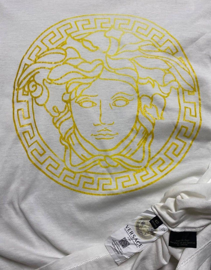 VERSACE MEDUSA HEAD GLITTER/FOIL GRAPHTEE - WHITE (Category: Shirts) located in Manila. Submitted by ztfirtfritz (Listing ID 1464704602, Image 3). Description: VERSACE MEDUSA HEAD GLITTER/FOIL GRAPHTEE - WHITE LEGIT SIZE 40 ON TAG WOMEN'S SMALL (IT40) MEASUREMENTS" SHOULDER: 18 SLEEVE: 8 PIT: 20 LENGTH: 27 MEDIUM TO LARGE VERY GOOD FLAWS: MINOR FADE ON PRINTS STILL PRESENTABLE 650 + SF.