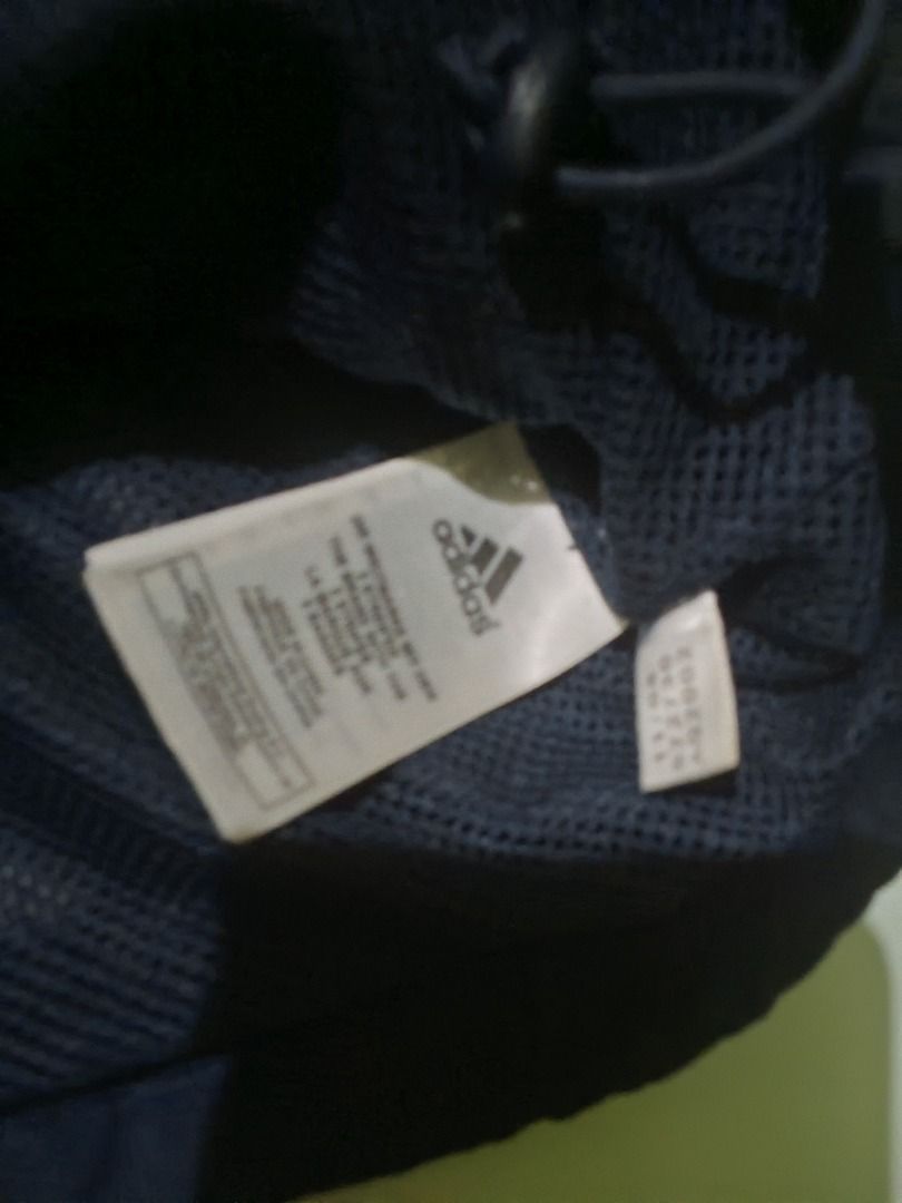 Vintage Adidas Navy Blue Windbreaker Jacket (Category: Coats, Jackets and Outerwear) located in Caloocan City. Submitted by mysticdog-6a6b (Listing ID 1464737411, Image 3). Description: - Brand: Adidas - Color: Navy blue with white accent stripes - Features: Embroidered logo, stand-up collar with snap button, and mesh interior lining - Fit: Adjustable bungee cord hem for a customizable fit - Style: Classic sporty look, ideal layering piece for br