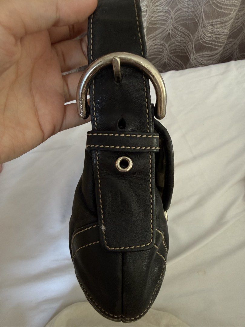 Vintage Coach Black Mini Soho Bag (Category: Luxury Bags & Wallets) located in Iligan City. Submitted by peachylovessoup (Listing ID 1464738421, Image 2). Description: -Black leather vintage Coach Mini Soho with contrast stitching and silver hardware -Front flap closure featuring a prominent metal buckle detail. -Adjustable single strap -Classic Y2K vintage aesthetic, great everyday size -Miffy Keychain is not included -Issues: Cracks on the hand
