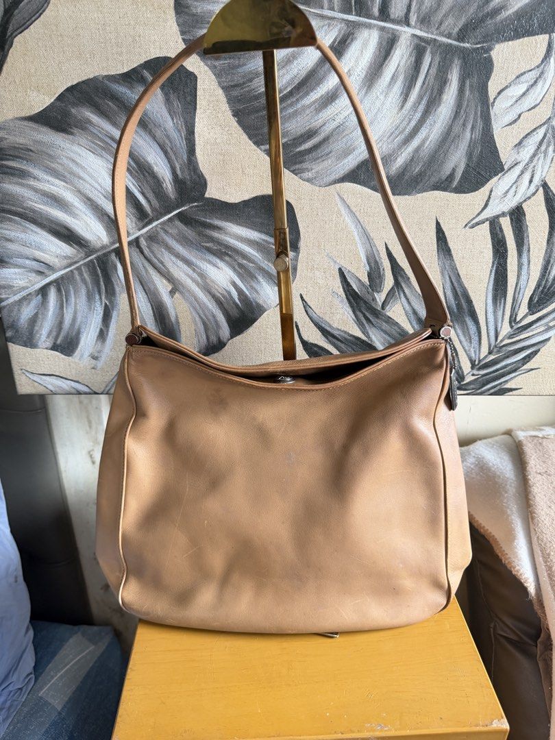 Vintage Coach Tan Leather Shoulder Bag (Category: Shoulder Bags) located in Quezon City. Submitted by good_finds_mnl (Listing ID 1464598883, Image 1). Description: Classic tan leather shoulder bag. Soft leather with a nice sheen. The strap is adjustable. Plenty of space inside for your essentials. A versatile bag for everyday use. Some minor scuffs on the leather from normal wear..