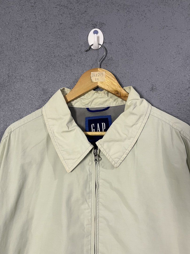 Vintage Gap Harrington Zip Up Jacket 2XL (Category: Coats, Jackets and Outerwear) located in Famy. Submitted by basicthrifted (Listing ID 1464701988, Image 2). Description: - Brand: Gap - Style: Zip-up jacket with classic collar - Color: Cream - Size: 2XL (Tag measurements: 31" x 27.5") - Features: Front pockets, button cuffs, and mesh inner lining - Condition: Pre-loved with minor stains on the collar and fabric (please check photos closely).