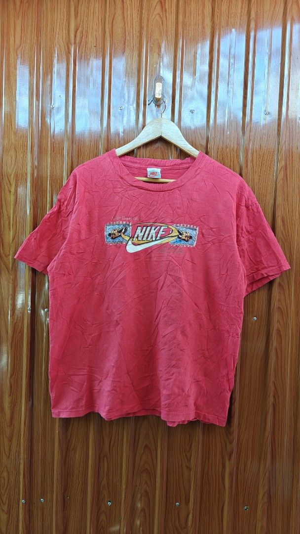 Vintage Nike T-shirt (Category: Tshirts & Polo Shirts ) located in San Francisco. Submitted by Intaw20 (Listing ID 1464713390, Image 1). Description: -Vintage Nike Tees - Brand: Nike 21.5 x 27 - Color: Red - Fit: Regular fit with classic crew neck and short sleeves - Details: Graphic print on chest and small Nike tag at the collar - Condition: Shows some natural wear and wrinkles from storage.