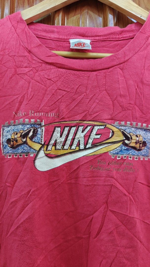 Vintage Nike T-shirt (Category: Tshirts & Polo Shirts ) located in San Francisco. Submitted by Intaw20 (Listing ID 1464713390, Image 3). Description: -Vintage Nike Tees - Brand: Nike 21.5 x 27 - Color: Red - Fit: Regular fit with classic crew neck and short sleeves - Details: Graphic print on chest and small Nike tag at the collar - Condition: Shows some natural wear and wrinkles from storage.