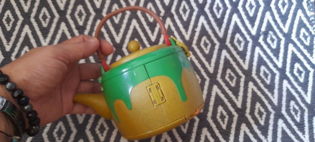 Vintage Polly Pocket Teapot Compact Playset (Category: Kids Toys) located in Bocaue. Submitted by marajapansurplus (Listing ID 1464580176, Image 2). Description: - Vintage Polly Pocket Teapot Compact Playset - Yellow and green teapot with brown handle - Opens to reveal a cute house interior - Ideal for imaginative play - Great for collectors and kids who enjoy small world play.