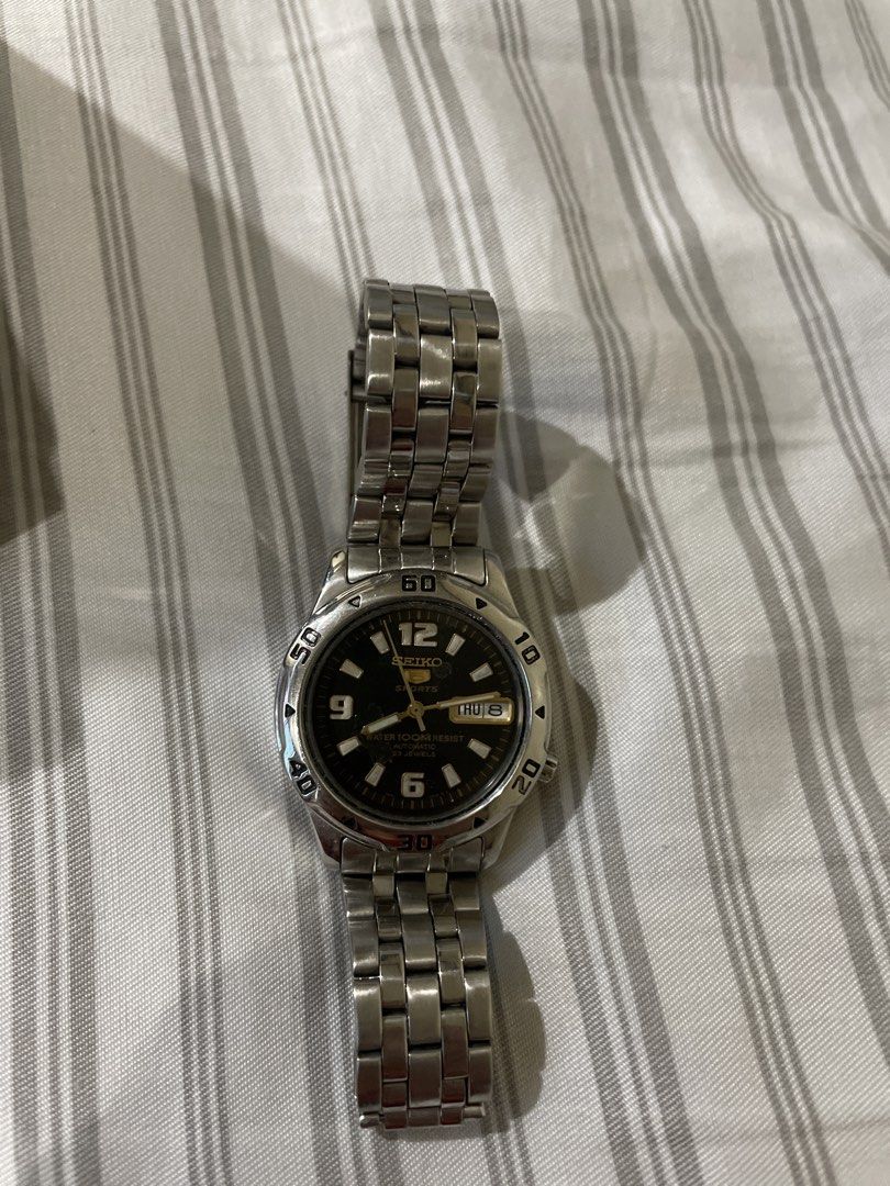 vintage Seiko 5 Automatic Watch with Extra Links (Category: Men's Watches) located in Bacoor. Submitted by pastforward.ph (Listing ID 1464664209, Image 1). Description: - Seiko 5 Automatic Watch - Classic Black Dial - Day and Date Function - Durable Stainless Steel Bracelet - Includes Extra Links (in separate bag) - Authentic 'Seiko Japan' Clasp Engraving - Ideal Everyday Watch.