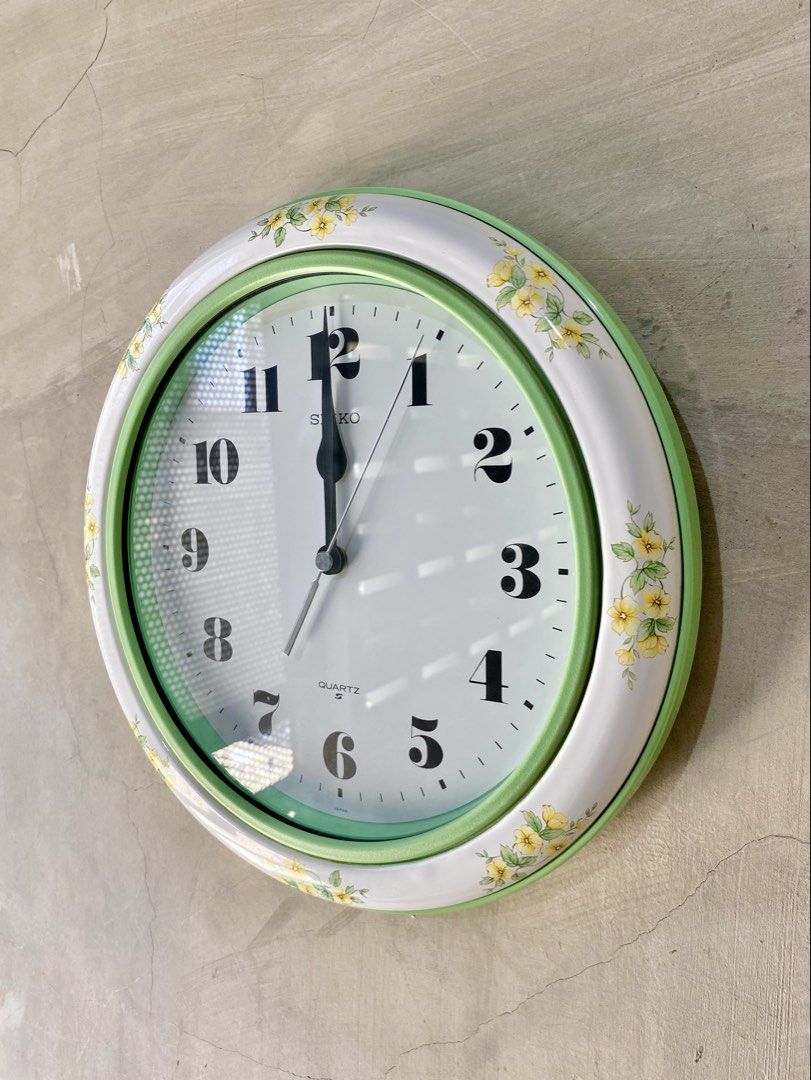 Vintage Seiko Quartz Wall Clock Model KS519M (Category: Clocks) located in Echague. Submitted by hissoraph (Listing ID 1464615196, Image 2). Description: Vintage Seiko Quartz Wall Clock Model KS519M - Made in Japan (Working, Like new condition) Key Characteristics & Features Design & Aesthetics: It features a distinctive retro design with a white outer border adorned with a yellow floral pattern. The inner bezel is finished in a vibrant pastel mi