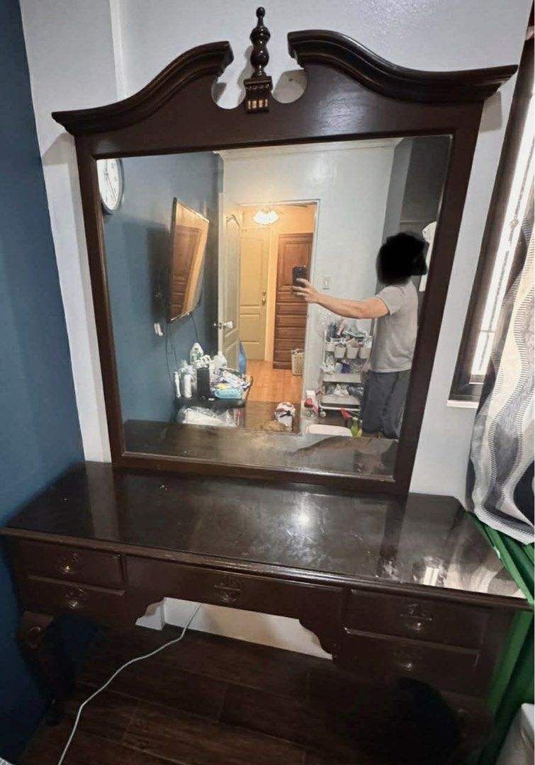 Vintage Wooden Dressing Table with Mirror (Category: Tables & Sets) located in Quezon City. Submitted by christelleceb23 (Listing ID 1464659059, Image 2). Description: - Vintage wooden dressing table - Features a large mirror - Multiple drawers for ample storage - Dark, polished wood finish - Minor surface wear, adding to its vintage charm - A timeless addition to any bedroom.