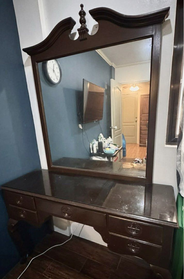 Vintage Wooden Dressing Table with Mirror (Category: Tables & Sets) located in Quezon City. Submitted by christelleceb23 (Listing ID 1464659059, Image 1). Description: - Vintage wooden dressing table - Features a large mirror - Multiple drawers for ample storage - Dark, polished wood finish - Minor surface wear, adding to its vintage charm - A timeless addition to any bedroom.