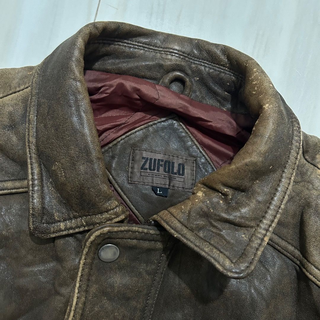 Vintage Zufulo Brown Leather Jacket (Category: Coats, Jackets and Outerwear) located in Sorsogon. Submitted by wayne.japon (Listing ID 1464661452, Image 3). Description: - Classic brown leather jacket with a distressed finish. - Two front pockets with button closures. - Button cuffs on sleeves. - Perfect for achieving a rugged aesthetic. Vintage Zufulo Japan Leather Jacket Good condition Leather 24x32 XL Issue on picture 350.