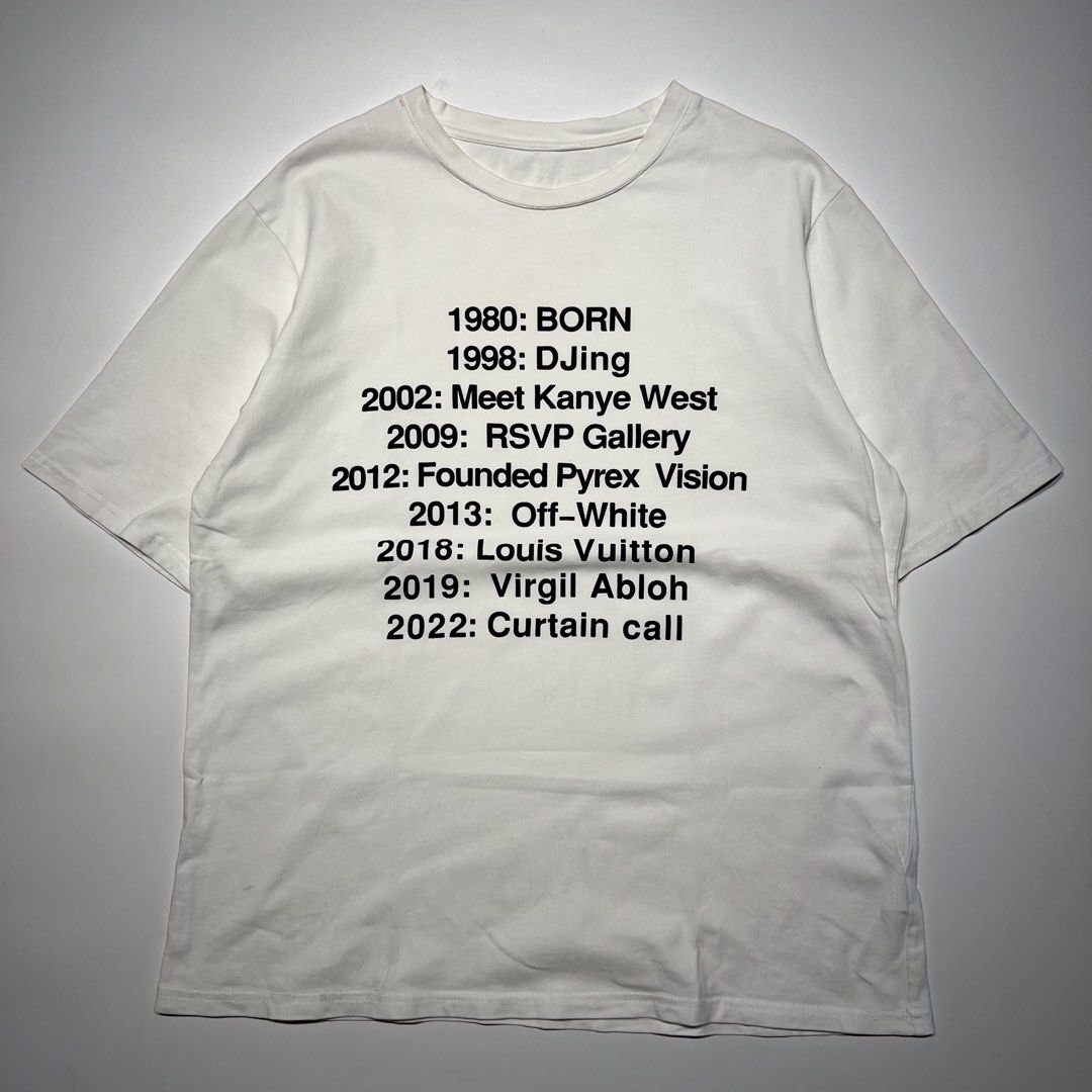 Virgil Abloh "Curtain Call" Legacy Timeline Tee (Category: Tshirts & Polo Shirts ) located in Balanga. Submitted by goodiegarments (Listing ID 1464584056, Image 3). Description: Virgil Abloh "Curtain Call" Legacy Timeline Tee A minimalist yet profound tribute to a modern fashion visionary. This white streetwear tee chronicles the monumental timeline of Virgil Abloh—from his early days DJing and founding Pyrex Vision, to taking the helm at Off-Whi