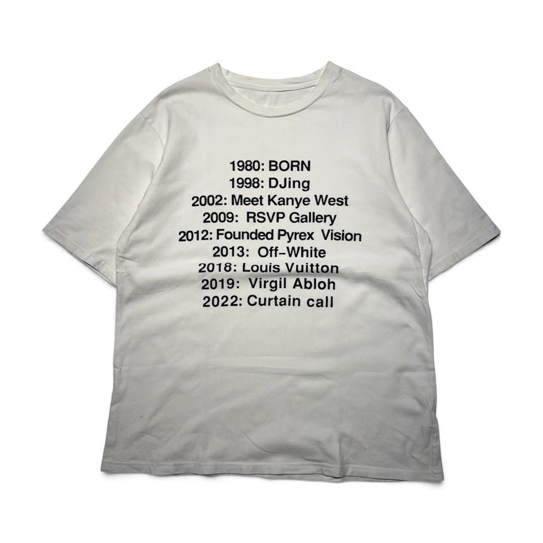Virgil Abloh "Curtain Call" Legacy Timeline Tee (Category: Tshirts & Polo Shirts ) located in Balanga. Submitted by goodiegarments (Listing ID 1464584056, Image 1). Description: Virgil Abloh "Curtain Call" Legacy Timeline Tee A minimalist yet profound tribute to a modern fashion visionary. This white streetwear tee chronicles the monumental timeline of Virgil Abloh—from his early days DJing and founding Pyrex Vision, to taking the helm at Off-Whi