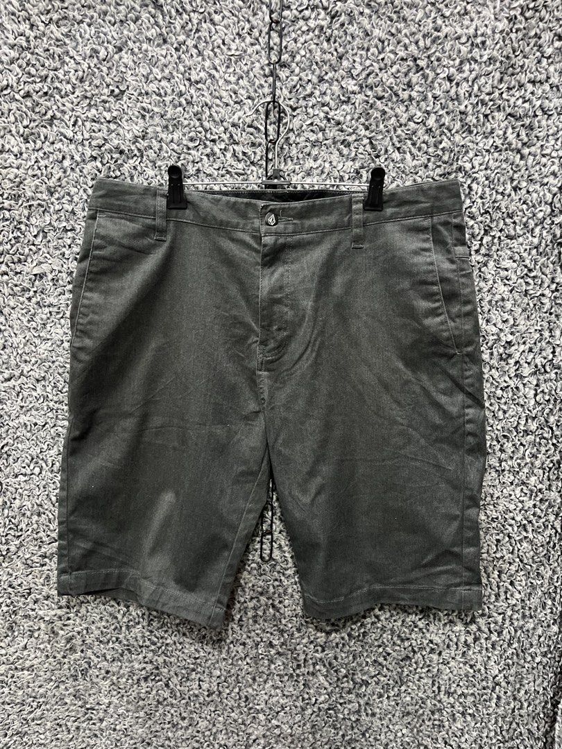 Volcom men's shorts | Size 34 (Category: Shorts) located in General Trias. Submitted by zrchustle.604 (Listing ID 1464626396, Image 1). Description: Volcom men's shorts in a dark charcoal grey colorway. They feature Volcom's signature asymmetrical back yoke stitching pattern across the upper rear panel, welted rear pockets, a classic flat-front construction, and the signature embroidered Volcom stone logo located on the lower back left leg..