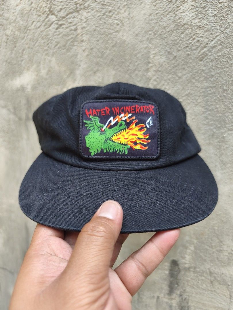 Volcom x Ozzy Wrong Black Snapback Cap Hater Incinerator Dragon Patch (Category: Caps & Hats) located in Bulacan. Submitted by THA_D_THRIFT (Listing ID 1464589542, Image 1). Description: - Brand: Volcom - Type: Snapback Cap - Color: Black - Design: Embroidered patch on front - Patch Details: Dragon and flames graphic - Patch Text: 'HATER INCINERATOR' - Closure: Adjustable snapback - Style: Casual wear 1250 + SF.