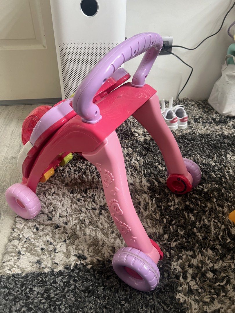 VTech First Steps Baby Walker - Pink (Category: Infant Playtime) located in Manila. Submitted by rosiecs33 (Listing ID 1464579475, Image 2). Description: Key Features: Detachable panel: Can be removed for floor play. Interactive learning: Features piano keys, shape sorters, spinning gears, and a toy phone. Development aid: Helps babies build walking skills and learn numbers, colors, and shapes. Original Price: Around ₱3,399 Selling it for : 1,500