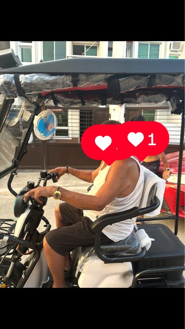 Wanyuan Electric Tricycle With Canopy And Storage (Category: Motorbikes for Sale) located in Manila. Submitted by jobithings (Listing ID 1464737921, Image 3). Description: Wanyuan electric tricycle with a full black roof canopy and front windshield. Includes handlebars, front storage basket, cushioned seating with backrest, and overhead fan. Rear storage box fitted behind the seat. Black and white frame design with LED light bar on top roof edge.