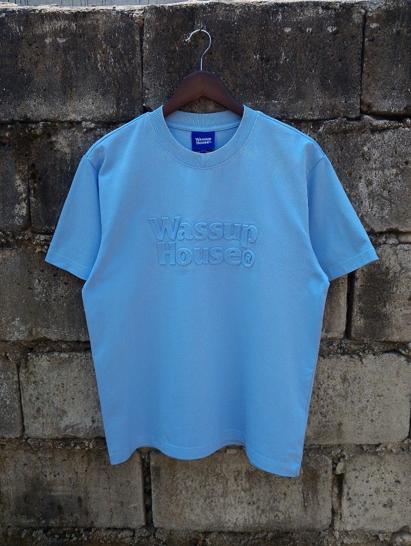 WASSUP HOUSE® TONAL EMBOSSED LOGO TEE (Category: Tshirts & Polo Shirts ) located in Baliuag. Submitted by retrovault83 (Listing ID 1464702333, Image 1). Description: ✨ Condition: 9–9.5/10 – Excellent Preloved / Like New Condition 📏 Size & Fit: Measurements: Width: 21 Length: 26 Fit: Standard / Relaxed Streetwear Fit ✅ Product Details & Features: • Color: Baby Blue / Light Blue • Tonal 3D raised/embossed "Wassup House®" chest logo • Fabric: 100% 