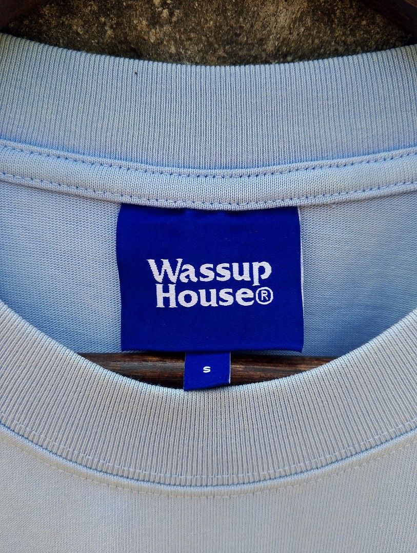 WASSUP HOUSE® TONAL EMBOSSED LOGO TEE (Category: Tshirts & Polo Shirts ) located in Baliuag. Submitted by retrovault83 (Listing ID 1464702333, Image 3). Description: ✨ Condition: 9–9.5/10 – Excellent Preloved / Like New Condition 📏 Size & Fit: Measurements: Width: 21 Length: 26 Fit: Standard / Relaxed Streetwear Fit ✅ Product Details & Features: • Color: Baby Blue / Light Blue • Tonal 3D raised/embossed "Wassup House®" chest logo • Fabric: 100% 