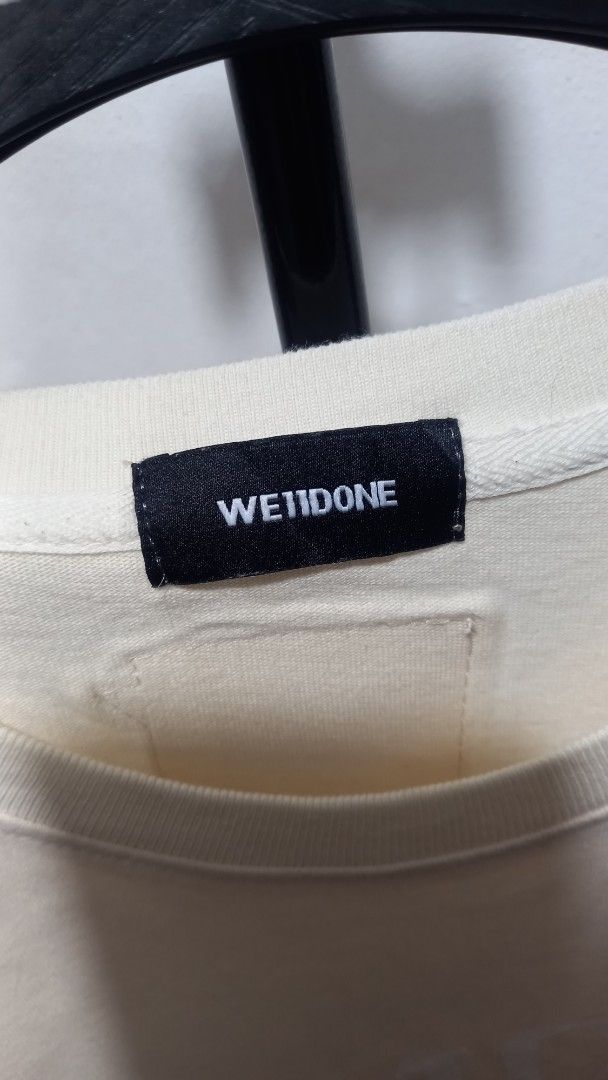 WE11DONE T-Shirt Cream Multi-Logo Print (Category: Tshirts & Polo Shirts ) located in Tarlac. Submitted by den420 (Listing ID 1464656975, Image 3). Description: - Brand: WE11DONE - Color: Cream - Design: Graphic print with multiple "WE11DONE" logos in various colors - Neckline: Classic crew neck - Sleeves: Short sleeves - Material: Comfortable fabric - Occasion: Perfect for casual wear.