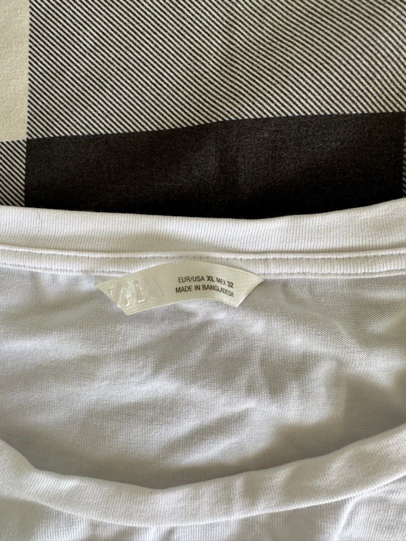 White Basic T-Shirt (Category: Shirts) located in Paranaque City. Submitted by declutterwyae (Listing ID 1464607072, Image 3). Description: - Classic white t-shirt - Simple and versatile design - Ideal for everyday wear - Tagged as EUR/USA XL, UK 32 - Made in Bangladesh.