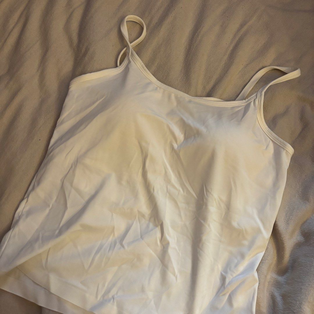 White Built-in Bra Tank Top (Category: Sleeveless) located in Cainta. Submitted by kairus.luckyfind (Listing ID 1464644296, Image 1). Description: FITS S-M similar to uniqlo quality - White tank top with integrated bra cups - Soft and comfortable material for daily wear - Features adjustable straps for a perfect fit - Mesh panel at the back enhances breathability - Versatile for layering or wearing as a standalone top.
