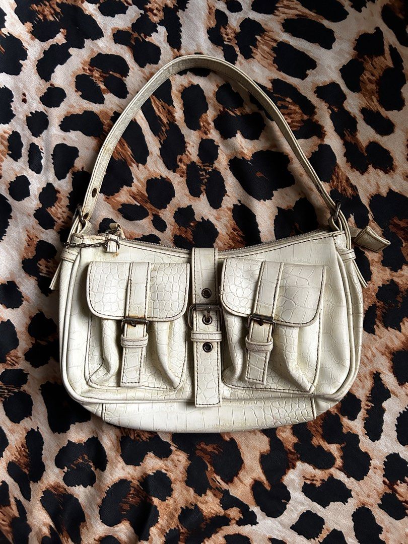 White Croc Embossed Shoulder Bag with Buckle Details (Category: Shoulder Bags) located in Los Banos. Submitted by samsukehiro (Listing ID 1464579639, Image 1). Description: - White shoulder bag with stylish croc-embossed texture. - Features two front pockets with secure buckle closures. - Zip top closure for main compartment. - Adjustable shoulder strap with buckle details. - Classic Y2K aesthetic, perfect for vintage lovers. - Please note: Minor