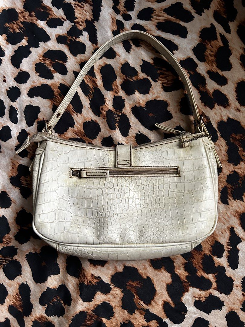 White Croc Embossed Shoulder Bag with Buckle Details (Category: Shoulder Bags) located in Los Banos. Submitted by samsukehiro (Listing ID 1464579639, Image 2). Description: - White shoulder bag with stylish croc-embossed texture. - Features two front pockets with secure buckle closures. - Zip top closure for main compartment. - Adjustable shoulder strap with buckle details. - Classic Y2K aesthetic, perfect for vintage lovers. - Please note: Minor