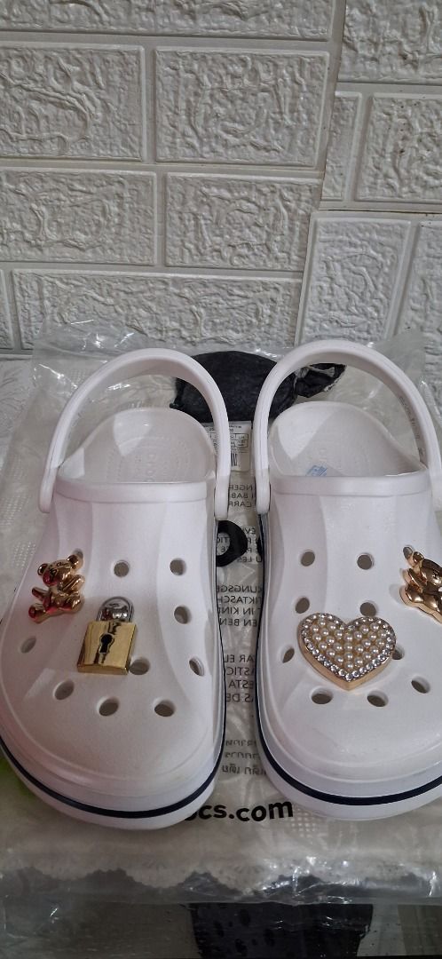 White Crocs with Teddy Bear, Lock, and Heart Charms (Category: Slippers and slides) located in Manila. Submitted by katkween23 (Listing ID 1464587899, Image 1). Description: - White Crocs with adorable charm decorations - Includes: Teddy bear charm, lock charm, heart charm with rhinestones - Fun and stylish design to express your personality - Easy slip-on, slip-off style - Ideal for everyday casual wear.