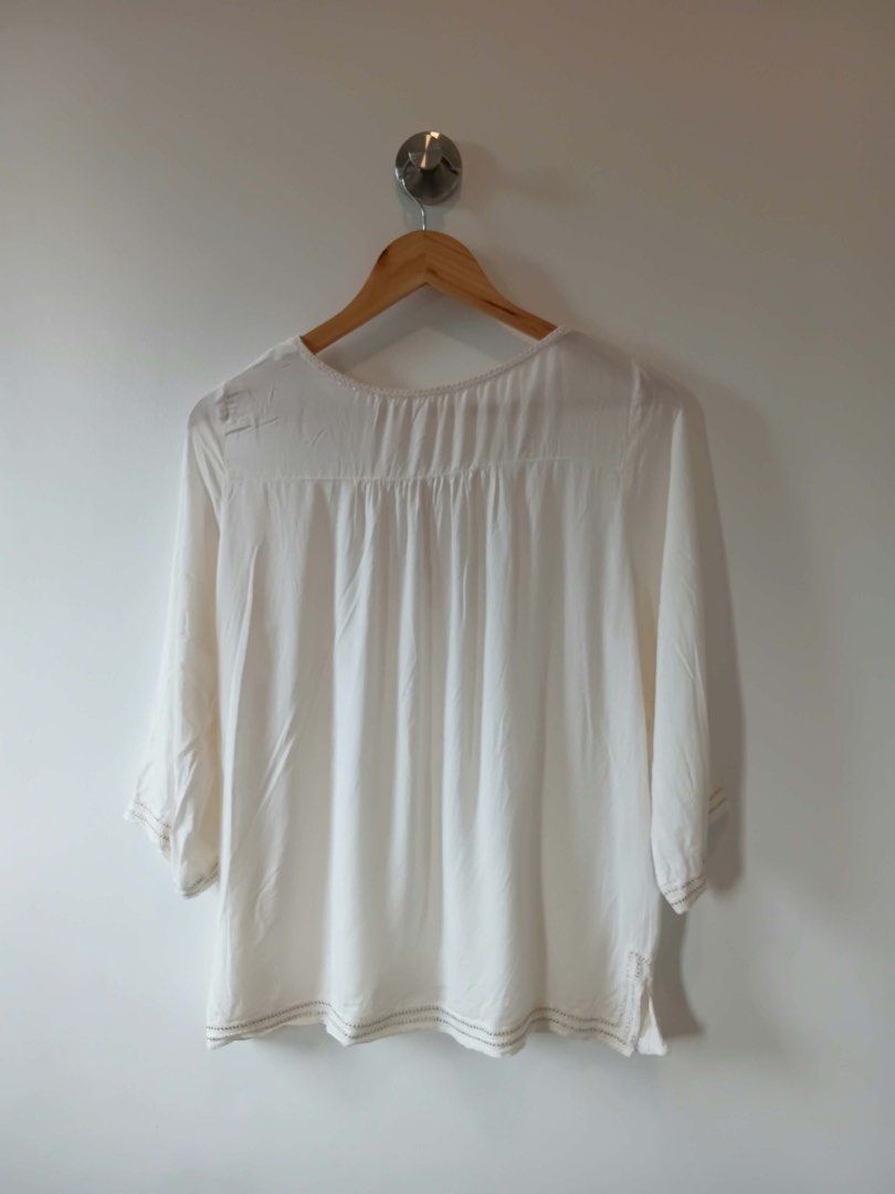 White Embroidered Blouse with Tie Neck (Category: Blouses) located in Manila. Submitted by wisecat.4a7eea (Listing ID 1464602445, Image 3). Description: - White 3/4 sleeve blouse - Delicate embroidery around neckline and cuffs - Front tie detail - Lightweight fabric for comfort - Versatile for casual or dressed-up looks.