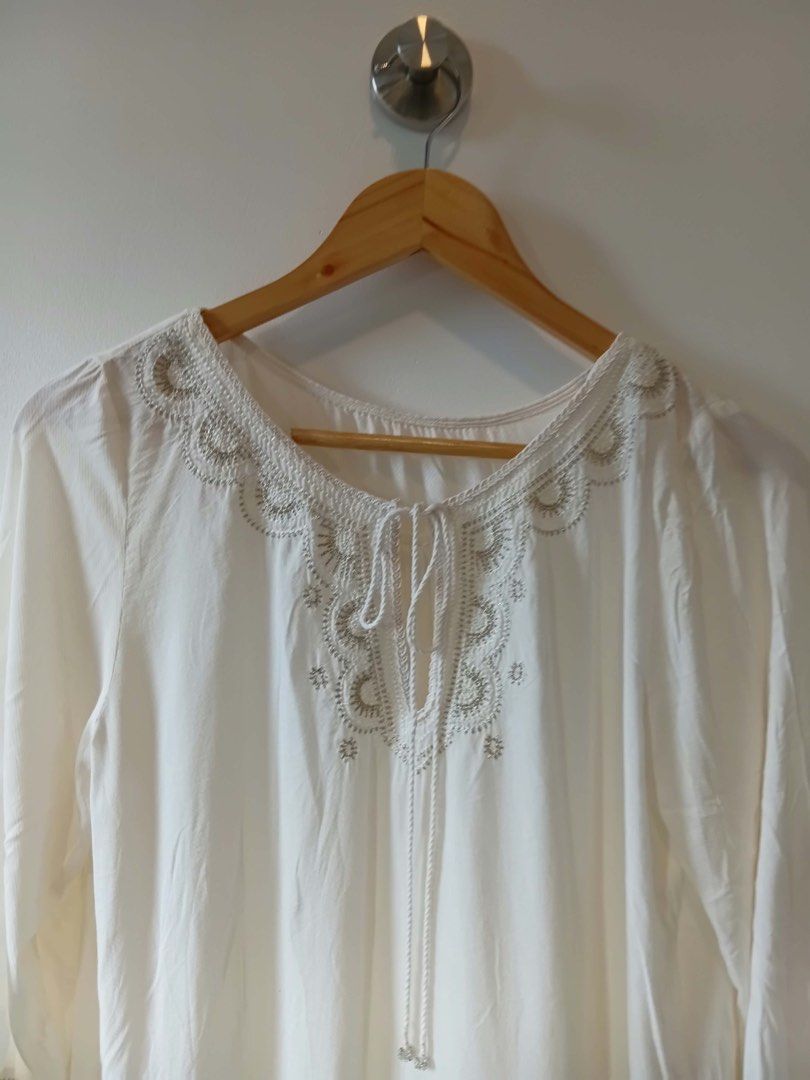 White Embroidered Blouse with Tie Neck (Category: Blouses) located in Manila. Submitted by wisecat.4a7eea (Listing ID 1464602445, Image 2). Description: - White 3/4 sleeve blouse - Delicate embroidery around neckline and cuffs - Front tie detail - Lightweight fabric for comfort - Versatile for casual or dressed-up looks.