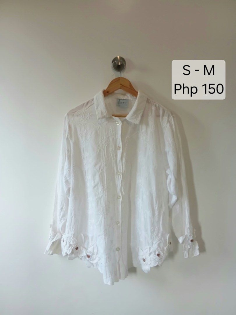 White Embroidered Button-Up Blouse S-M (Category: Blouses) located in Manila. Submitted by wisecat.4a7eea (Listing ID 1464634312, Image 1). Description: - White long-sleeved blouse - All-over intricate floral embroidery - Collared neckline - Button-up front - Unique scalloped hem with floral appliques and bead details - Versatile for casual or semi-formal wear - Size: S-M.