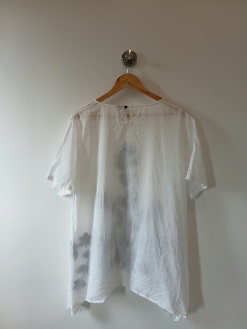 White Embroidered Top L-XL (Category: Blouses) located in Manila. Submitted by wisecat.4a7eea (Listing ID 1464606411, Image 2). Description: - Chic white top with elegant dark grey floral embroidery on the front. - Features short sleeves and a classic round neckline. - Designed for a relaxed, loose fit with a stylish asymmetrical hem. - Ideal for effortless casual wear. - Size L-XL..