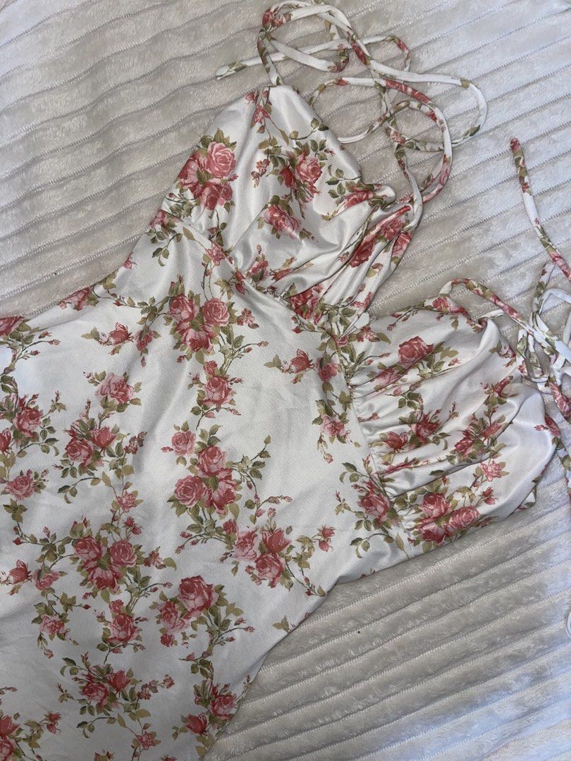 White Floral Satin Dress (Category: Dresses) located in Manila. Submitted by rare.yurichi (Listing ID 1464739018, Image 1). Description: Elegant silky satin-style fabric with an all-over pink rose floral print. Features a ruched bustier-style neckline, delicate adjustable tie straps, and a flattering fitted silhouette that flows down to a midi/maxi length. Perfect for date nights, summer events, or picnics.