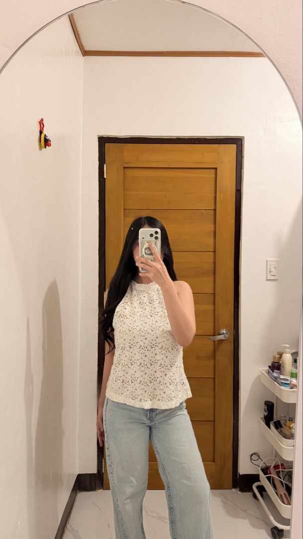 White Lace Halter Neck Top with Tie Back (Category: Sleeveless) located in Tarlac. Submitted by mariebiscuitttttt (Listing ID 1464642004, Image 3). Description: - Cute white lace halter neck top - Tan lining underneath - Tie closure at the back - Versatile: perfect for casual day out or night events - Pairs well with jeans or skirts - Features a pretty floral lace pattern.