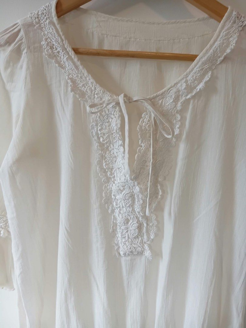 White Lace Trimmed Blouse M-L (Category: Blouses) located in Manila. Submitted by wisecat.4a7eea (Listing ID 1464603231, Image 2). Description: - Elegant white blouse with delicate lace details. - Lace accents around the neckline and sleeves. - Flared three-quarter sleeves with elasticated cuffs. - Adjustable tie detail at the front neckline. - Made from comfortable and airy fabric. - Ideal for a chic casual look..